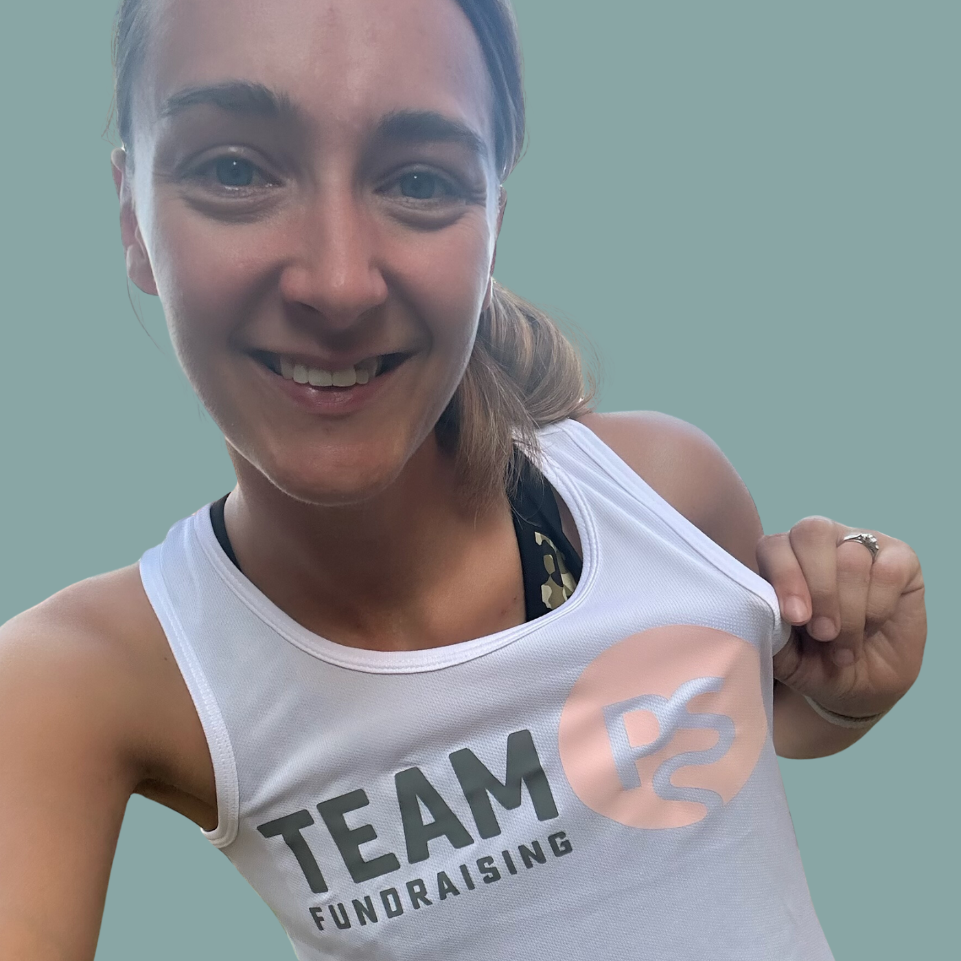 Woman holding her fundraising shirt smiling